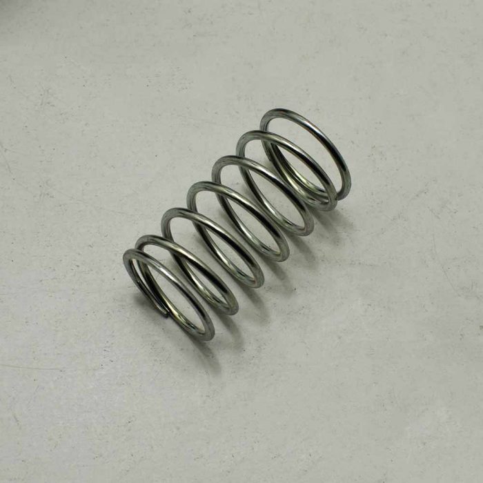 Spring for engine cover lock